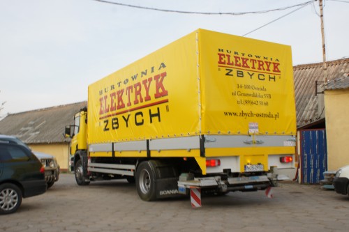 Plandeka reklamowa na naczepie samochodu ciężarowego marki Scania P230.